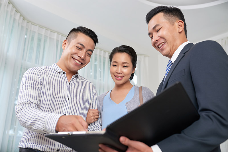 real estate agent showing docs to clients